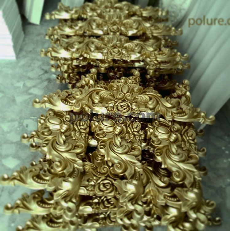 Stacked Metallic Gold Pediment Crests in Factory