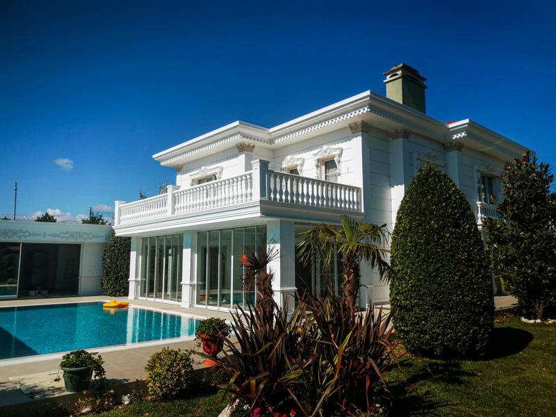 White Villa Facade with Turquoise Pool Terrace