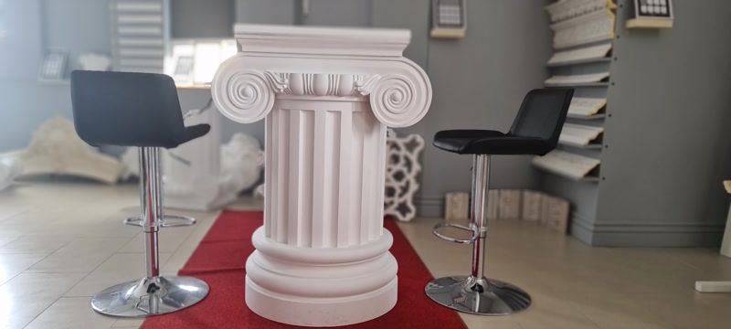 White Ionic Column Pedestal Table in Showroom