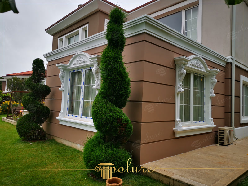 Oblique Photo of Brown Villa Corner with White Window Trims