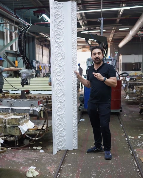 Presenter shows complete patterned cornice length on factory floor