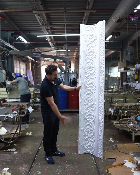 Full cornice piece standing upright in wide workshop view