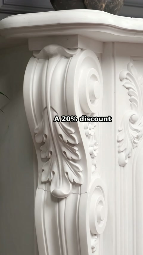 Die weiße Kaminsäule verfügt über fließende Kurven und vertiefte Blattdetails.