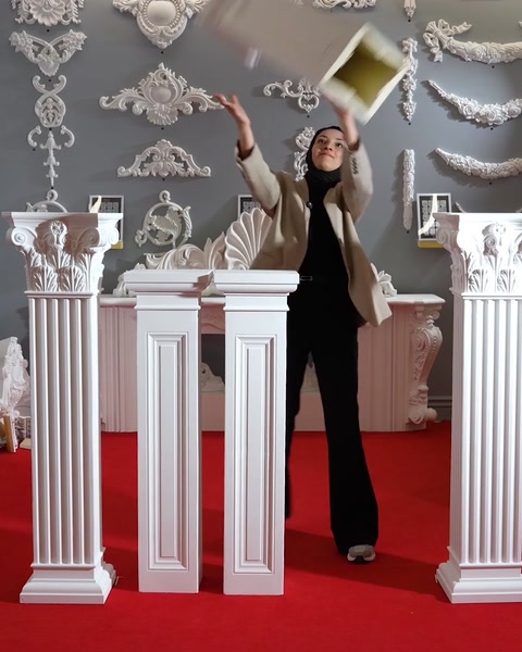 Placing a capital atop assembled polyurethane pedestal columns
