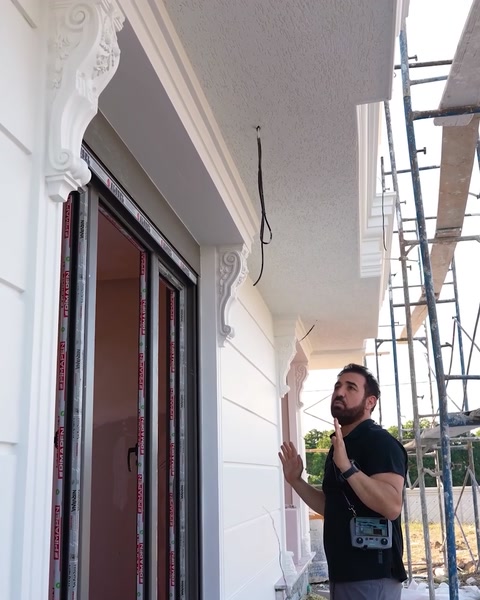 Pracovník dosahující na instalaci podrobnosti konzoly na vrcholu sloupu