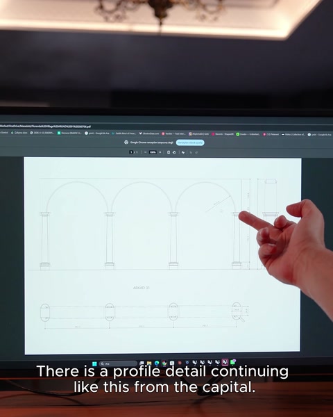 A hand points across the arcade elevation and its repeated arches