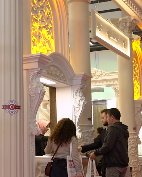 Visitors examining polyurethane pilaster and mirror frame display