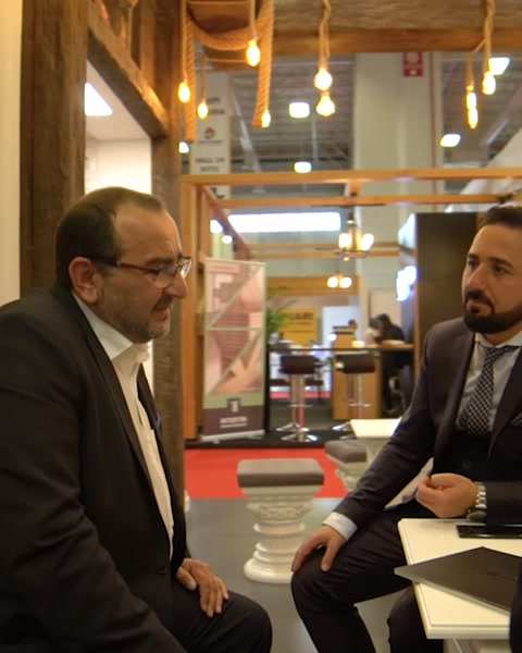 Businessmen discussing product samples at Polure exhibition booth