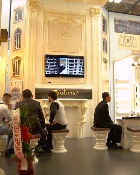 Wall-mounted television showing presentation beside decorative columns