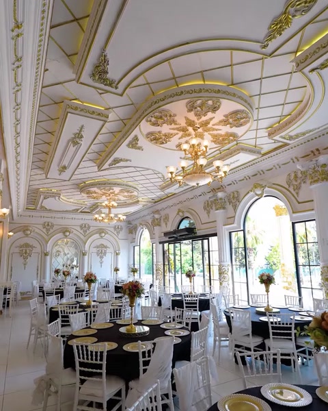 Soffitto della sala per matrimoni con cornice decorativa dorata e lampadari di cristallo