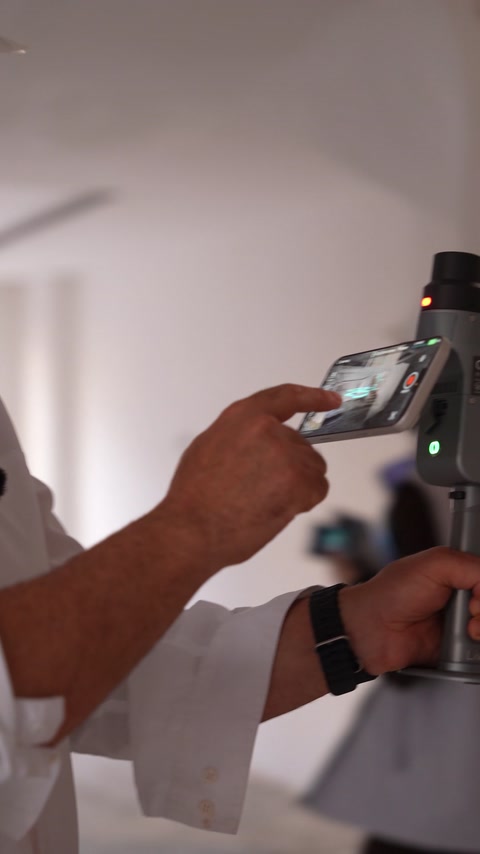 A handheld scanner captures interior geometry at the construction site