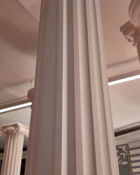 Tight close-up of flutes running up the round column shaft
