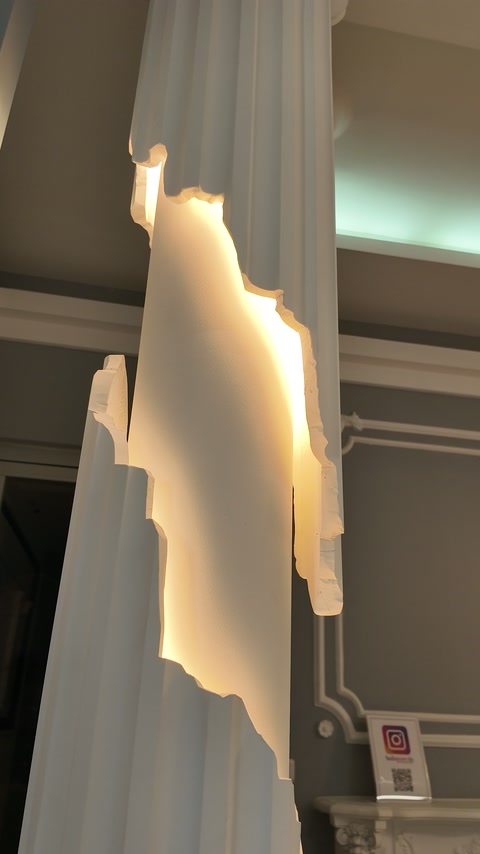 Seitenansicht einer kannelierten Säule mit beleuchteten Ornamentmustern