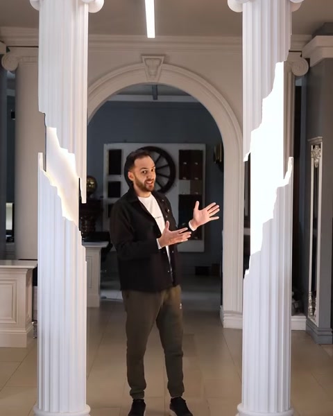 Interior hallway with arched doorway and matching decorative columns