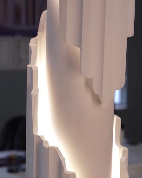Textured column surface glowing softly from concealed LED strip