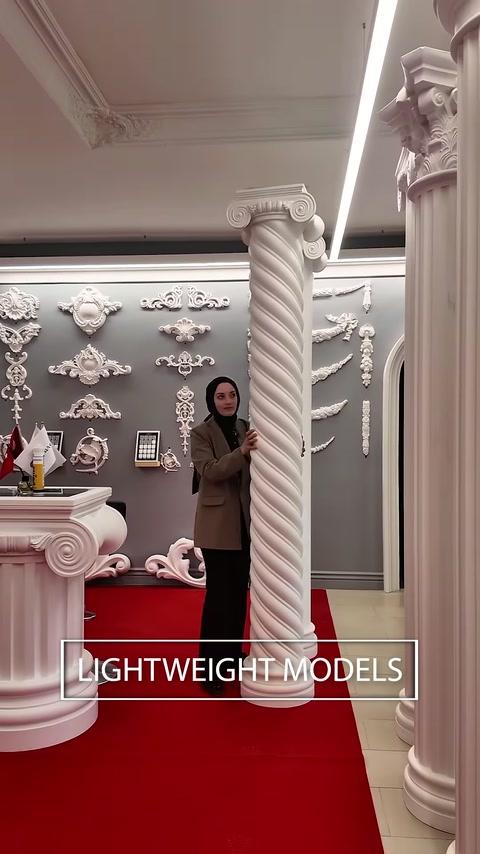 Une colonne classique torsadée se trouve parmi des chapiteaux et des éléments muraux ornementaux.