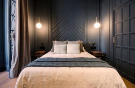 Modern Classic Bedroom with Navy Panels and Romantic White Accents