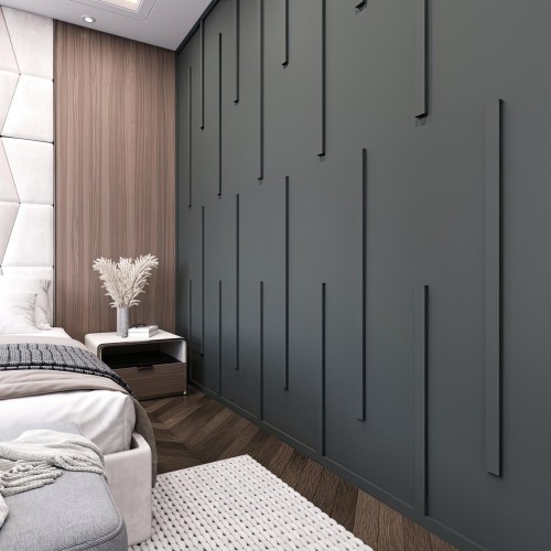 Design di cornici a parete in poliuretano per interni moderni classici <h2>Eleganza delle cornici in poliuretano</h2><p>Le <strong>cornici</strong> in poliuretano sono elementi decorativi che uniscono leggerezza, resistenza e facilità di installazione. Nel design moderno, questi dettagli vengono usati per creare <strong>profondità</strong> e ritmo visivo sulle superfici, senza appesantire l'ambiente.</p><h2>Geometria verticale e giochi di ombre</h2><p>La parete mostra applicazioni sottili e verticali, disposte a diverse altezze e spaziature. Questo motivo geometrico lineare genera dinamismo visivo e un raffinato gioco di ombre che valorizza la texture scura del fondo. I listelli verticali in rilievo aggiungono <strong>dimensione</strong> e movimento, trasformando la parete in un elemento scenografico.</p><h2>Contrasto e armonia materica</h2><p>L'effetto visivo delle cornici è rafforzato dal contrasto con i pannelli in legno naturale adiacenti, i quali introducono un calore cromatico che bilancia le tonalità più fredde. Questo accostamento amplifica l'identità <strong>moderna</strong> e al contempo mantiene un tocco <strong>classico</strong> attraverso la proporzione e la disposizione regolare.</p><h2>Cenno storico</h2><p>L'uso delle cornici e degli stucchi risale all'architettura antica, in cui motivi decorativi lineari venivano usati per sottolineare ordine e verticalità. Le moderne reinterpretazioni in poliuretano riprendono questi concetti in chiave contemporanea.</p><h2>Versatilità del design</h2><p>Grazie alla facile personalizzazione di forme, colori e finiture, le cornici in poliuretano si adattano sia a spazi minimali che ad ambienti più ricchi di dettagli. Possono rafforzare la geometria delle stanze e delineare chiaramente le superfici, diventando strumento fondamentale del <strong>design</strong> d'interni contemporaneo.</p>
<p>Le cornici in poliuretano offrono un connubio perfetto tra tradizione e innovazione. Questo materiale leggero e resistente permette un montaggio semplice. Le linee verticali sottili creano ritmo visivo senza appesantire. Il contrasto tra superfici scure e legno naturale apporta calore. Le geometrie lineari hanno radici nell'architettura classica. Oggi vengono reinterpretate con uno stile più <strong>moderno</strong>. La disposizione irregolare dei listelli aggiunge originalità. Le ombre generate aumentano la <strong>profondità</strong> percettiva. Questi elementi donano movimento alla parete. Il design resta elegante ma sobrio. Le tonalità fredde riequilibrano la luminosità della stanza. I tessuti morbidi accostati completano la scena. Il <strong>design</strong> minimalista acquisisce carattere. La versatilità del poliuretano ne amplia l’uso. Questa soluzione rende gli interni raffinati e <strong>classici</strong> al tempo stesso.</p>