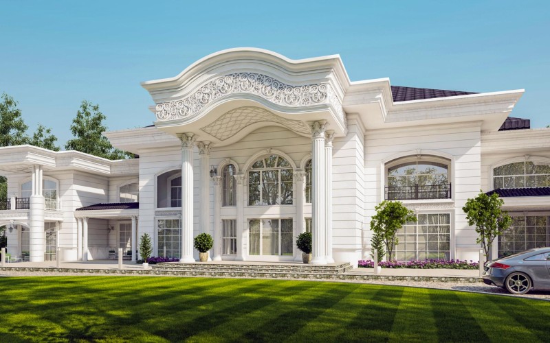 Villa clásica con fachada de poliuretano y detalles decorativos prekast <h2>Diseño exterior con estilo clásico</h2><p>La villa muestra un elaborado diseño que combina <strong>poliuretano</strong> y recubrimiento <strong>prekast</strong>, aportando resistencia, estética y sofisticación. Las columnas estriadas con capiteles corintios evocan la arquitectura grecorromana, y los arcos en gran formato amplifican la sensación de altura.</p><p>La parte superior del pórtico exhibe un friso con motivos en espiral y relieves florales, mientras que el techo presenta un patrón geométrico fino. Este detalle ornamental no solo decora, sino que establece un diálogo con la tradición clásica del uso de molduras talladas, recordando brevemente los estilos arquitectónicos del Renacimiento.</p><h2>Equilibrio decorativo y materiales modernos</h2><p>La superficie blanca segmentada por líneas horizontales refuerza la geometría y genera uniformidad visual. El <strong>diseño clásico</strong> se combina con la durabilidad moderna del <strong>poliuretano decorativo</strong>, permitiendo preservar detalles finos en todas las molduras. Las ventanas arqueadas, con marcos decorativos, equilibran elegancia y luminosidad.</p><ul><li>Columnas altas y simétricas con base robusta</li><li>Relieves florales y curvas onduladas</li><li>Amplias ventanas arqueadas con molduras</li><li>Uso equilibrado de blanco y ornamentación en relieve</li></ul><p>El resultado es un espacio monumental que combina linealidad, ornamentos y proporciones, uniendo tradición arquitectónica clásica con técnicas constructivas modernas.</p>

<p>La fachada clásica de la villa refleja elegancia atemporal. El uso de <strong>poliuretano</strong> permite molduras definidas y resistentes. El recubrimiento <strong>prekast</strong> garantiza durabilidad y ligereza. Las columnas estriadas evocan arquitectura antigua. Los capiteles corintios añaden detalle artístico. Los arcos amplios proporcionan amplitud visual. El friso floral sobresale en la entrada principal. Las curvas onduladas crean dinamismo ornamental. La simetría estructural inspira majestuosidad. Las amplias ventanas enriquecen la luminosidad. La integración con vegetación añade frescura. La combinación de ornamentos genera armonía. El <strong>diseño clásico</strong> se potencia con materiales modernos. La geometría refinada marca proporciones equilibradas. El conjunto logra un efecto de <strong>arquitectura de lujo</strong> único.</p>