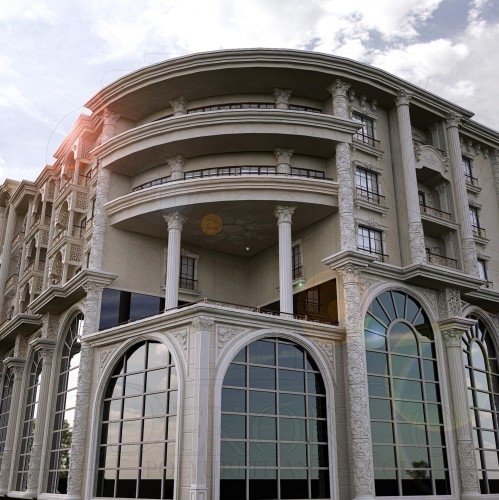 Poliuretani dekorativ në fasadat e hoteleve me elegancë klasike <h2>Fasada klasike me poliuretan dekorativ</h2><p>Ndërtesa e hotelit dallon për harmoni të jashtëzakonshme midis <strong>elemeteve dekorative</strong> prej poliuretani dhe kompozimit arkitekturor të frymëzuar nga stilet klasike evropiane. Harqet e mëdha eliptike të dritareve krijojnë një raport ritmik me kolonat cilindrike që mbajnë strukturën e ballkoneve të gjerë.</p><p>Përdorimi i <strong>poliuretani</strong> në korniza dhe panele zbukuruese lejon realizimin e reliefeve floreale dhe gjeometrike me lehtësi dhe qëndrueshmëri, duke garantuar një stil që përforcon identitetin e hotelit. Ornamentet e pasura me motive gjeometrike dhe floreale në sipërfaqet anësore krijojnë një kontrast estetik me xhamat e zinj të mëdhenj, duke e balancuar modernitetin me klasiken.</p><h2>Detaje dhe histori arkitektonike</h2><p>Kapitale të frymëzuara nga epoka romake dhe shtyllat me proporcione të përpikta i japin objektit një gjallëri historike, duke e lidhur me traditat e <strong>neoklasicizmit</strong>. Një element i veçantë është ndërthurja midis formave rrafshore të dritareve dhe mbushjeve voluminoze dekorative, që sjellin thellësi vizuale.</p><ul><li>Harqe eliptike të theksuara me korniza të punuara.</li><li>Kolona cilindrike me kapitale dekorative.</li><li>Motive floreale dhe gjeometrike në relieve.</li><li>Përdorim funksional dhe estetik i <strong>poliuretanit</strong>.</li></ul><p>Këto elemente të përpunuara krijojnë një stil unik ku <strong>ornamentet</strong>, <strong>fasada</strong> dhe përmasat madhështore ndërthuren për të ofruar një përvojë vizuale të paharrueshme.</p>

<p>Fasada e një hoteli me elemente prej <strong>poliuretani</strong> ofron një kombinim të balancuar ndërmjet klasikes dhe modernes. Harqet e larta eliptike theksojnë vertikalitetin në mënyrë elegante. Kolonat cilindrike shtojnë një ndjesi madhështie dhe harmonie. Ornamentet në relieve floreale e bëjnë sipërfaqen më dinamike. Kornizat e theksuara të dritareve i japin thellësi kompozimit. Përzgjedhja e <strong>ornamenteve</strong> prej poliuretani siguron qëndrueshmëri dhe lehtësi pune. Simetria e projektimit pasqyron një qasje estetike të sofistikuar. Kombinimi i xhamave të zinj dhe motiveve klasike krijon kontrast modern. Ballkonet me hapësira gjysmë-rrethore japin ritëm vizual fasadës. Motivet gjeometrike ndërthuren me linja të buta dekorative. Ndikimi i <strong>neoklasicizmit</strong> është i dukshëm në kolonat dhe kapitale. Struktura arrin të harmonizojë luksin me elegancën funksionale. Përdorimi i materialeve të lehta sjell efikasitet estetik. Ky stil mund të frymëzojë projekte të tjera në arkitekturën urbane. Fasada përfundimisht pasqyron një identitet të fortë dhe të përjetshëm.</p>