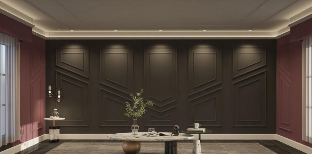 Moderne klassische Wohnzimmereinrichtung mit Polyurethan Zierleisten <h2>Moderne klassische Gestaltung mit Polyurethan-Zierleisten</h2><p>Das Wohnzimmer kombiniert <strong>Polyurethan</strong>-Zierleisten mit einem klar strukturierten modernen Klassizismus. Die Wandpaneele sind in dunklem Farbton gehalten und folgen einem harmonischen Rhythmus aus rechteckigen Rahmen und diagonalen Linien.</p><p>Die diagonalen Muster erzeugen Bewegung und Dynamik, während die geometrisch angeordneten Felder eine ruhige Balance schaffen. Dieses Zusammenspiel verkörpert die Verbindung aus Funktionalität und dekorativer Eleganz.</p><h2>Geometrische Details und Raumwirkung</h2><p>Die auffälligen <strong>Zierleisten</strong> mit schräg verlaufenden Linien verleihen der Wand Tiefe und Struktur. Durch gezielte Lichtspots entstehen Schattenspiele, die die feinen Reliefs verstärken. Die Verwendung von <strong>Marmor</strong> bei Couchtischen setzt klassische Akzente, während die abstrakten Figuren einen zeitgemäßen Touch hinzufügen.</p><p>Historisch gesehen wurden dekorative Wandrahmen bereits in antiken römischen Innenräumen eingesetzt. Polyurethan als moderner Werkstoff ermöglicht heute die Wiederbelebung dieser Tradition in leichter, beständiger Form.</p><h2>Farb- und Stilkonzept</h2><p>Die Kombination von dunklen Wandflächen mit tiefen Burgundertönen an den Seitenwänden schafft ein luxuriöses Ambiente. Diese Farbkombination wirkt sowohl elegant als auch modern. Das Zusammenspiel von <strong>klassischen Mustern</strong> und modernen Materialien vermittelt einen zeitübergreifenden Eindruck.</p><ul><li>Geometrische Reliefdetails betonen die Wandgestaltung.</li><li>Gezielte Beleuchtung verstärkt die Wirkung der Linien.</li><li>Marmor- und Metallakzente fügen Raffinesse hinzu.</li></ul>

<p>Polyurethan-Zierleisten schaffen in diesem Wohnzimmer eine spannende Verbindung zwischen Moderne und Klassik. Die dunklen Wandpaneele werden durch Reliefmuster mit diagonalen Linien aufgelockert. Die klaren Rahmenstrukturen verleihen dem Raum Beständigkeit. Die gezielte Beleuchtung hebt die Formen hervor. Besonders markant wirkt die symmetrische Anordnung. Dadurch entsteht Tiefe und Eleganz. Ergänzt wird das Konzept durch Möbel mit Marmor- und Metallakzenten. Diese Kombination bringt eine luxuriöse Ausstrahlung. Gleichzeitig bleibt der Stil zeitlos. Der Einsatz von <strong>Polyurethan</strong> erlaubt filigrane Gestaltung. Die geometrischen Ornamente erinnern an historische klassische Räume. Dennoch wirkt das Ergebnis modern und frisch. Auch die weinroten Seitenwände fördern den Kontrast. Die Wandreliefs bringen Dynamik in die Fläche. Insgesamt entsteht eine ausgewogene Raumwirkung.</p>