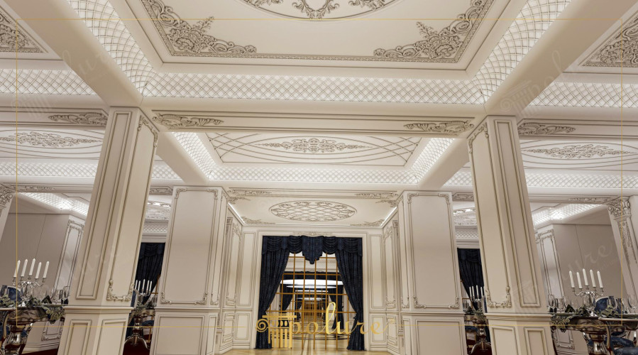 Klassische Innenarchitektur mit Polyurethan für langlebige Hochzeitssaalgestaltung <h2>Klassische Polyurethan-Innenräume für Hochzeitsäle</h2><p>Die hier gezeigte Gestaltung illustriert die Verwendung von <strong>Polyurethan</strong> als langlebiges Material, das im Innenraum zugleich funktional und dekorativ eingesetzt wird. Die Deckenflächen sind mit feinen Reliefs, floralen Ornamenten und geometrischen Strukturen verziert, die einen luxuriösen Gesamteindruck schaffen.</p><p>Auffällig sind die feinen <strong>geometrischen Muster</strong>, die gitterartig eingesetzt und durch weiche Beleuchtung hervorgehoben werden. Diese Mustergestaltung verleiht dem Raum räumliche Tiefe und schlichte Eleganz. Ergänzt werden diese Details durch klassisch proportionierte <strong>Säulen</strong>, die in filigranen Rahmen eingefasst sind.</p><p>Historisch betrachtet greift die Komposition auf Elemente der europäischen Klassik des 18. Jahrhunderts zurück, etwa auf ornamentale Stuckarbeiten mit floralen Symbolen und Relief-Medaillons. Diese Zitate klassizistischer Innenräume sind hier in eine moderne, funktionale Formensprache übertragen.</p><p>Wesentliche Akzente bilden die dunklen Vorhänge und die goldfarbenen Elemente im Interieur, die im Kontrast zu den hellen Wand- und Deckenflächen stehen. Dadurch wird die Balance zwischen <strong>Eleganz</strong> und Funktionalität erreicht. Besonders hervorzuheben sind die dekorativen Felder in den Decken, die mit <strong>Ornamentik</strong> und Reliefrahmungen die visuelle Komposition vollenden.</p><ul><li>Polyurethan als stilprägendes Material</li><li>Geometrische Gittermotive und florale Reliefs</li><li>Kombination von Weiß und kontrastierenden Farben</li></ul><p>Durch die Kombination dieser Gestaltungsmerkmale wird ein <strong>zeitloses Design</strong> geschaffen, das besonders für feierliche Anlässe wie Hochzeiten geeignet ist.</p>

<p>Diese Innenarchitektur zeigt einen Hochzeitssaal, der durch <strong>Polyurethan</strong> Verkleidungen mit filigranen Ornamenten Harmonie ausstrahlt. Klassische florale Muster fügen sich elegant in rechteckige und ovale Rahmen. An der Decke dominieren rautenähnliche <strong>geometrische Muster</strong>, die durch indirektes Licht verstärkt werden. Säulen mit feinen Reliefverzierungen verleihen Tiefe und Struktur. Dunkle Vorhänge setzen einen starken Kontrast zu den hellen Flächen. Goldene Elemente unterstreichen die festliche Atmosphäre. Diese Komposition wirkt gleichzeitig traditionell und modern. Die Materialien wurden so gewählt, dass sie Stil und Beständigkeit vereinen. Polyurethan bringt Leichtigkeit sowie praktische Vorteile in der Gestaltung. Besonders eindrucksvoll ist die Integration filigraner Rahmen in klar gegliederte Wandfelder. Solche Gestaltung erinnert an die Eleganz klassischer Stuckarbeiten. Sie strahlt Würde und Feierlichkeit aus. Die Balance zwischen Ornamentik und Geometrie bleibt stets gewahrt. Durch die Kombination entsteht eine luxuriöse doch ruhige Umgebung. Diese Innenarchitektur macht einen Hochzeitssaal zeitlos und unverwechselbar.</p>