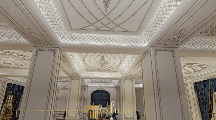 Klassieke trouwzaal met polyurethaan panelen en ornamenten <h2>Een tijdloze klassieke trouwzaal</h2><p>De inrichting van deze zaal is een voorbeeld van hoe <strong>polyurethaan</strong> kan worden gebruikt om rijke en verfijnde details te realiseren. De plafonds zijn gedecoreerd met een combinatie van geometrische <strong>ruitpatronen</strong> en sierlijke medaillons, waardoor een ritmisch en elegant geheel ontstaat. De subtiel geïntegreerde verlichting accentueert de diepte van de ornamenten en laat de witte oppervlakken zacht glanzen.</p><p>De pilaren zijn voorzien van reliëfs met klassieke motieven die doen denken aan historische stijlen zoals Korinthische en Ionische architectuur, waarin verfijnde ornamentiek een centrale rol speelde. Deze historische toets wordt hier in een moderne context geplaatst door het gebruik van duurzaam materiaal.</p><h2>Decoratieve details en samenhang</h2><p>De wandpanelen en pilaren zijn subtiel omlijst en versierd met sierlijke lijsten, terwijl de plafonds voorzien zijn van symmetrische patronen die elegantie uitstralen. Door het gebruik van <strong>ornamenten</strong>, fijne <strong>rozetten</strong> en een uitgekiende compositie ontstaat een sfeer die zowel monumentaal als uitnodigend is.</p><ul><li>Geometrische plafondstructuren zorgen voor balans en harmonie.</li><li>Decoratieve pilaren versterken de grandeur van de zaal.</li><li>Duurzaam polyurethaan maakt de afwerking licht, sterk en onderhoudsvrij.</li></ul><p>Het resultaat is een verbluffende trouwzaal die modern comfort combineert met een rijk klassiek karakter, ideaal voor vieringen waar stijl en traditie samenkomen.</p>
<p>Deze klassieke trouwzaal belichaamt elegantie in elk detail. De plafonds tonen subtiele cirkelvormige patronen die in balans zijn met strakke lijnen. De muren en pilaren zijn voorzien van zorgvuldig uitgewerkte ornamenten. Het gebruik van duurzaam <strong>polyurethaan</strong> geeft een lichte maar sterke basis aan de decoratie. Fraaie <strong>rozetten</strong> sieren de plafonds en versterken de harmonie. De geometrische ruitvormen geven ritme en verfijning. Een zacht verlichtingsplan benadrukt de diepte van de details. Klassieke invloeden zijn zichtbaar in de sierlijke reliëfs. Het interieur vindt balans tussen luxe en rust. Een gevoel van tijdloze grandeur vult de ruimte. De structuren werken samen om een vloeiende beweging te suggereren. Subtiele contrasten geven helderheid en elegantie. De compositie onderstreept een klassieke maar moderne uitstraling. De zaal biedt een prestigieuze sfeer voor ceremonies. Het geheel vormt een ideale setting voor een onvergetelijke beleving.</p>