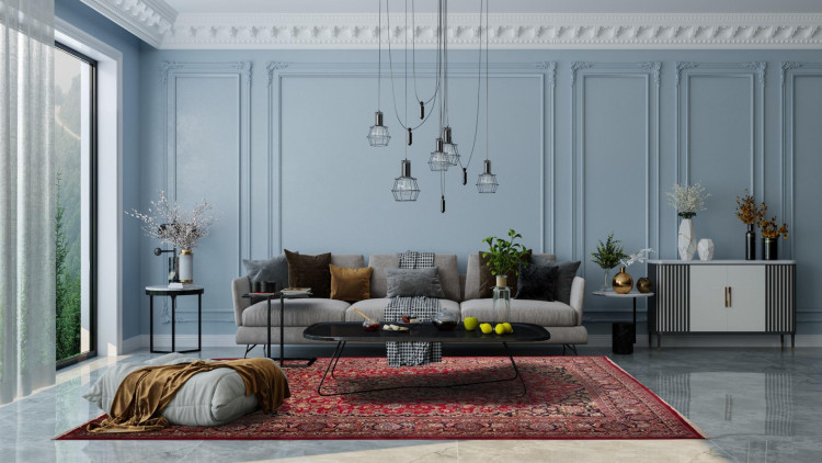 Neoklassisches Wohnzimmer mit Polyurethan-Wandpaneelen und eleganten Stuckelementen <h2>Neoklassische Eleganz mit Polyurethan</h2><p>Das Wohnzimmer zeigt eindrucksvoll, wie <strong>Polyurethan</strong>-Wandpaneele eine Wandgestaltung in reine Eleganz verwandeln können. Die großformatigen rechteckigen Rahmen sind streng gegliedert und durch zarte Ornamente akzentuiert, während die Deckenleiste mit ihren detaillierten floralen Formen die klassische Linie verstärkt.</p><p>Die Kombination eines hellblauen Wandtons mit den Stuckelementen verstärkt die ruhige und dennoch herrschaftliche Stimmung des Raumes. Ein roter Teppich mit fein gearbeiteten floralen <strong>Mustern</strong> und symmetrischen Ornamenten setzt ein starkes visuelles Fundament. Diese Teppichgestaltung, die an persische Traditionen erinnert, ergänzt das historische Flair.</p><p>Das Sofa in Grau wirkt modern, wobei die Kissen in Gold, Schwarz und Braun zusätzliche dekorative Akzente setzen. Ein schwarz gehaltenes Couchtisch-Design verstärkt den Kontrast. Die herabhängenden geometrischen Leuchten bilden ein starkes Bindeglied zwischen klassischem und modernem Ausdruck.</p><h2>Stil und Geschichte</h2><p>Die Tradition der neoklassischen Innenarchitektur ist von der Antike inspiriert, besonders von strikten Linien und Räumen mit harmonischer Symmetrie. Ähnliche Stuck- und Paneeltechniken wurden schon im 18. Jahrhundert verwendet, damals gefertigt aus Gips, heute jedoch praktisch durch <strong>Polyurethan</strong> umgesetzt, das sowohl leicht als auch langlebig ist.</p><ul><li>Detaillierte Wandrahmen in symmetrischer Anordnung</li><li>Kombination von klassischem Teppich und modernen Möbeln</li><li><strong>Stuckelemente</strong> mit floralen Reliefs</li><li>Moderne geometrische Hängelampen</li><li>Edelstahl- und Glaselemente für Akzente</li></ul><p>Das Zusammenspiel dieser Komponenten führt zu einem ausgewogenen Dialog zwischen Vergangenheit und Gegenwart.</p>

<p>Dieses neoklassische Wohnzimmer vereint klassische Wandgestaltung und moderne Details. Polyurethan-Wandpaneele sorgen für präzise Strukturen. Dekorative Stuckelemente verleihen dem Raum Eleganz. Der rote Teppich zeigt detaillierte florale Muster. Symmetrische Ornamente betonen Harmonie. Das graue Sofa schafft eine ruhige Basis. Zierkissen in warmen Farben fügen Kontrast hinzu. Geometrische Hängeleuchten bringen moderne Klarheit. Glänzende Dekorobjekte aus Metall wirken luxuriös. Glasvasen verstärken den leichten Charakter. Die Farbpalette verbindet Blau, Grau und Rot. <strong>Polyurethan</strong> ist leicht und langlebig. Das Zusammenspiel verschiedener Texturen verstärkt die Wohnlichkeit. Der Raum zeigt ein Gleichgewicht von Tradition und Moderne. Insgesamt entsteht ein stilvoller, zeitloser Gesamteindruck.</p>